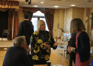 A woman from Carewatch speaking to a couple who have come to see the event.